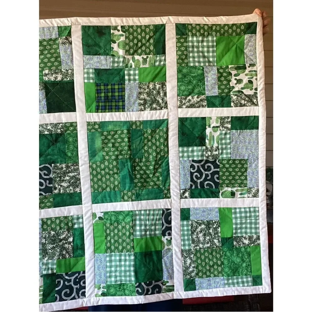 New without tags. Medley of Green Fabrics with White Borders Quilt